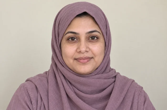 Later portrait of the same fictional woman wearing a hijab, with natural age-related facial changes